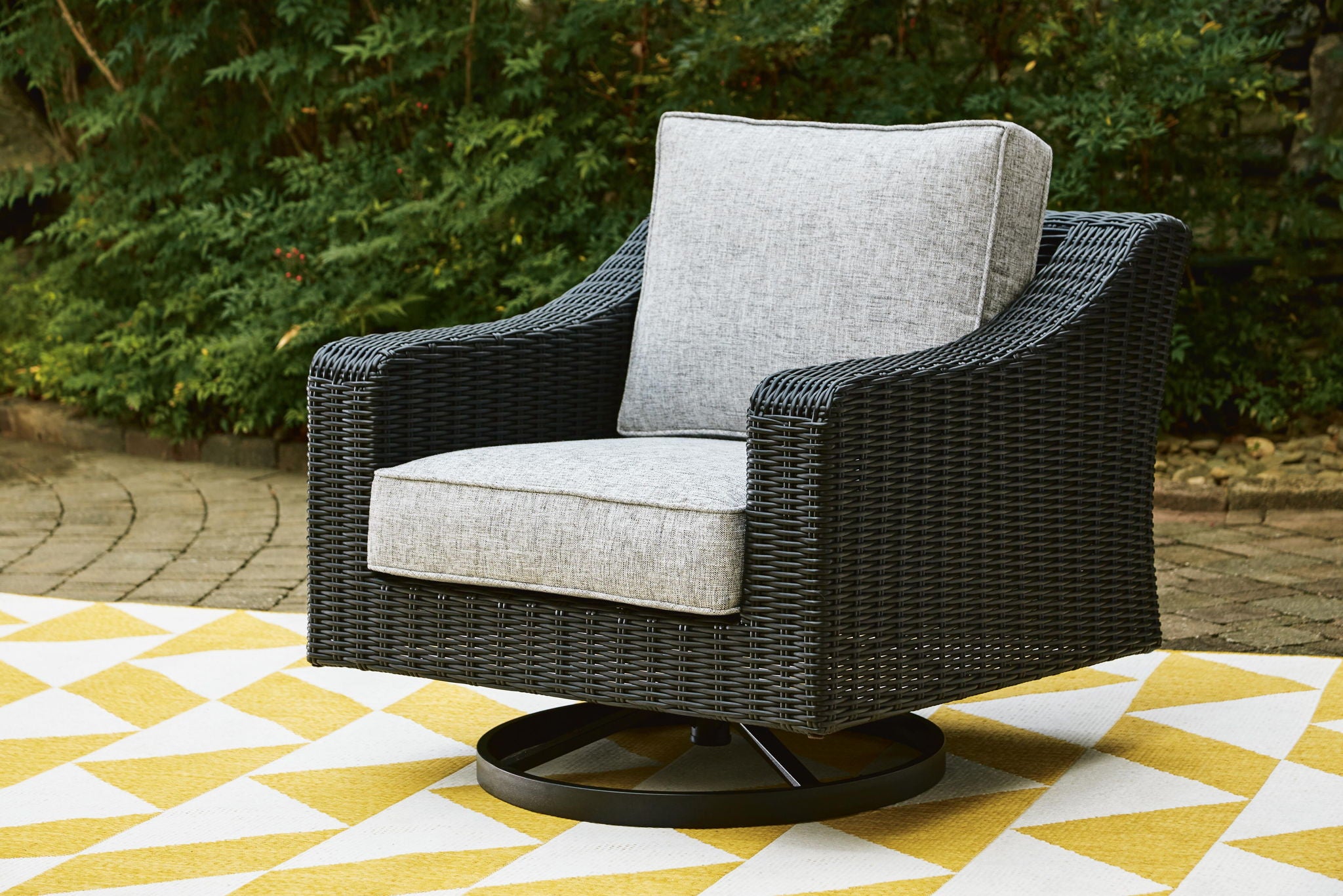 Black woven swivel lounge chair with light gray seat and back cushions