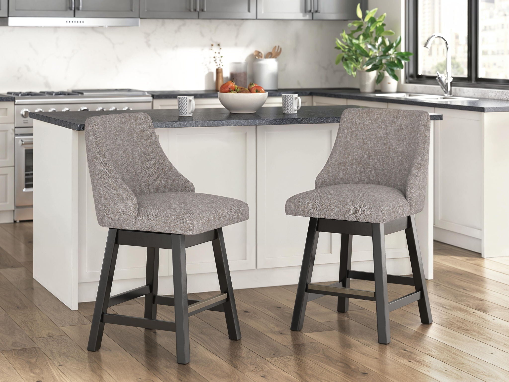 Pair of upholstered barstools with rounded backs, dark gray-brown seats, tapered dark legs