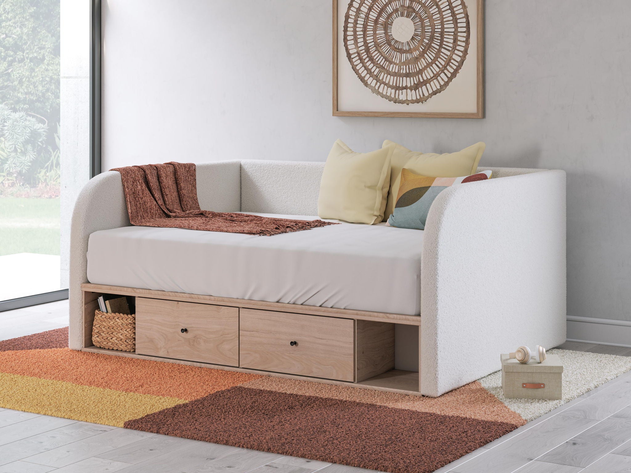 Beige upholstered day bed with two under-bed drawers and side cushioning