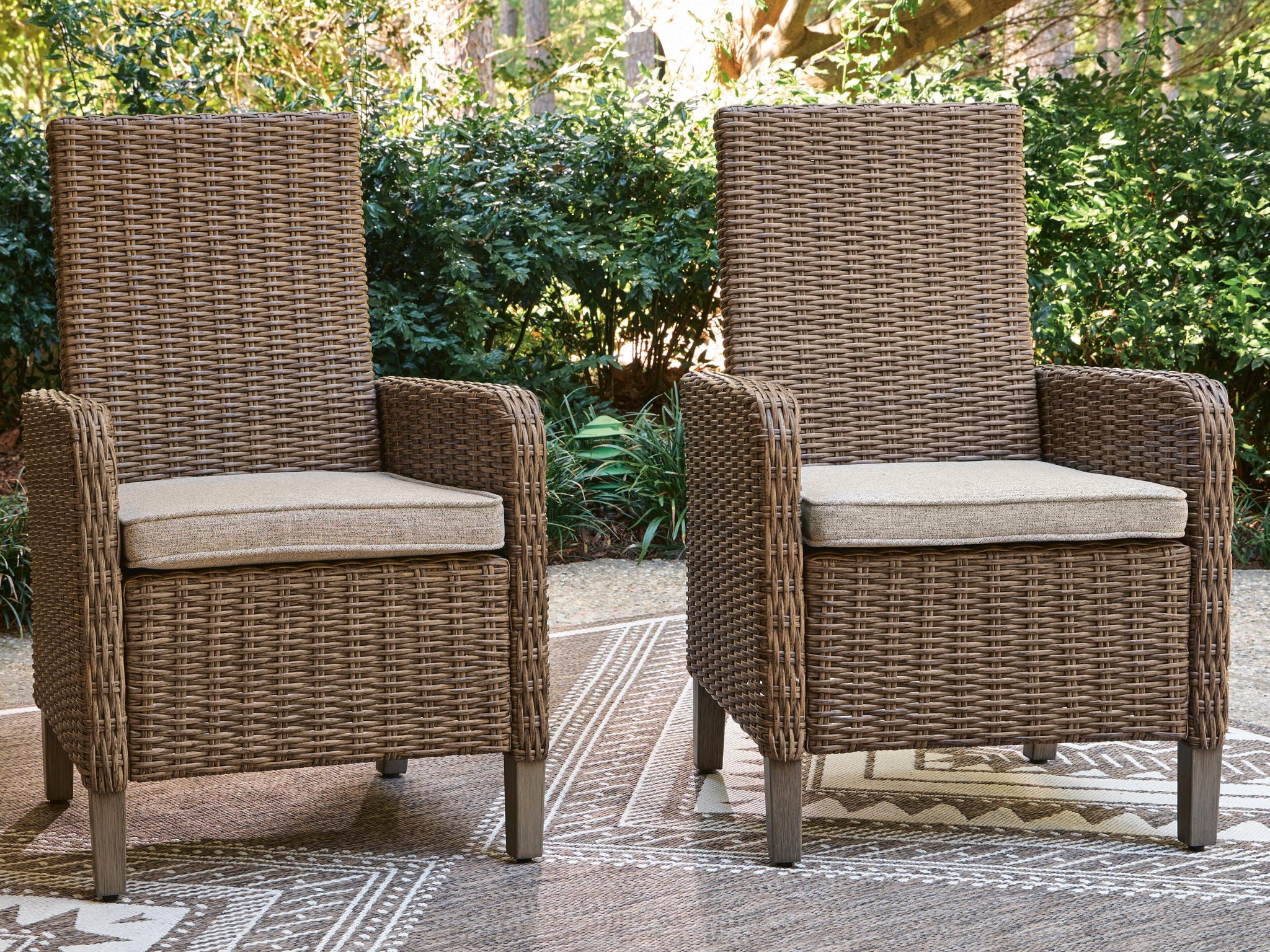 Set of 2 beige woven armchairs with seat cushions, armrests, and legs