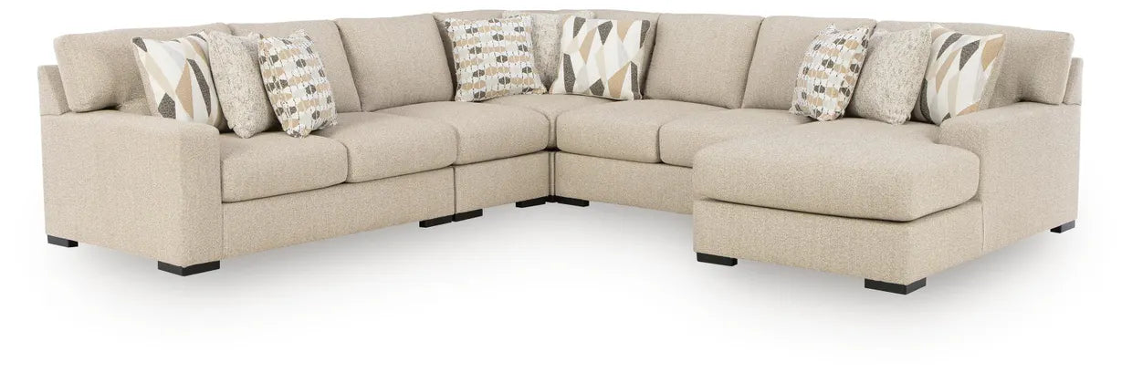 Laurelgrove corner sectional sofa in pebble fabric with chaise sections and patterned pillows
