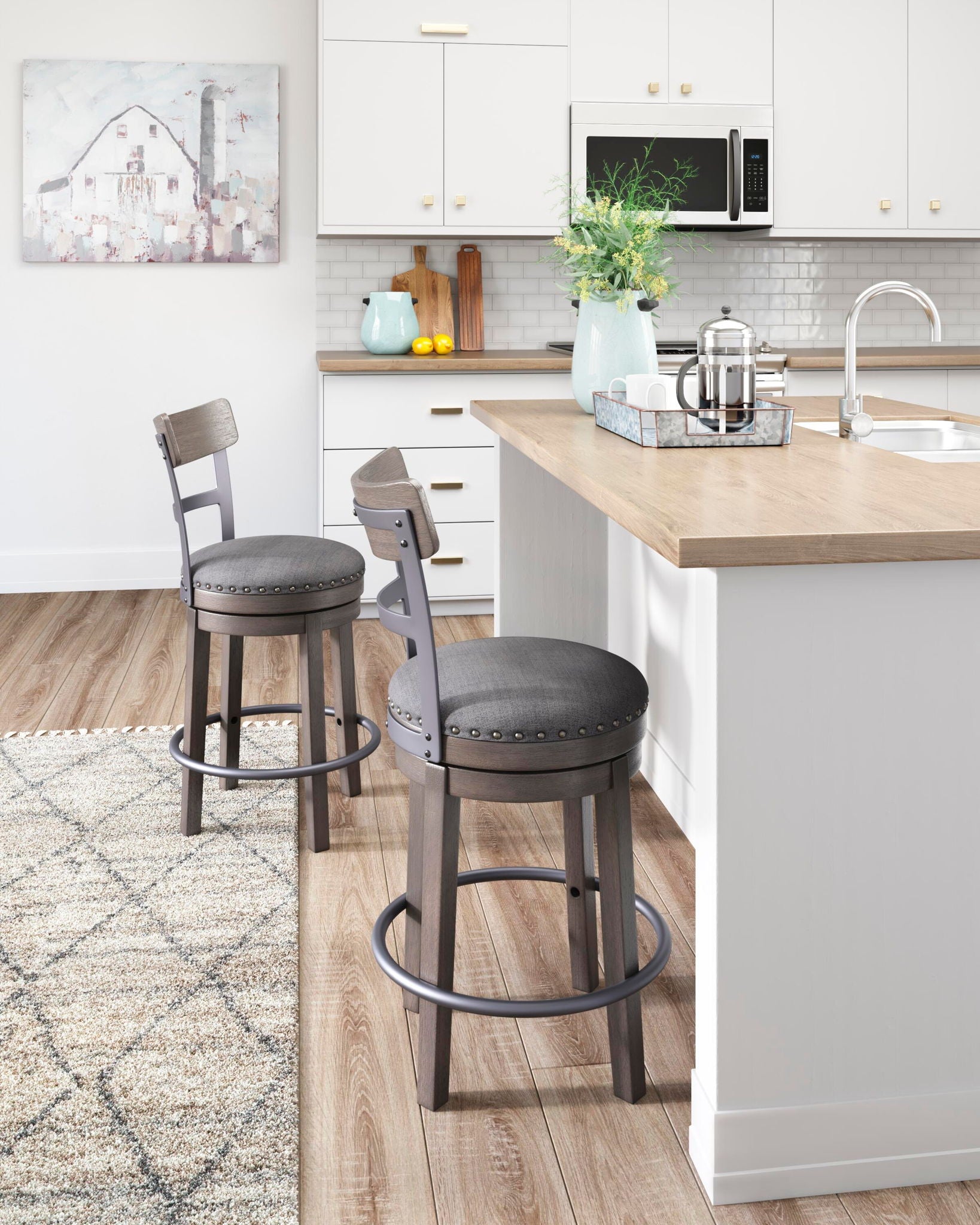 Set of two gray swivel bar stools with upholstered seats, nailhead trim, and footrests