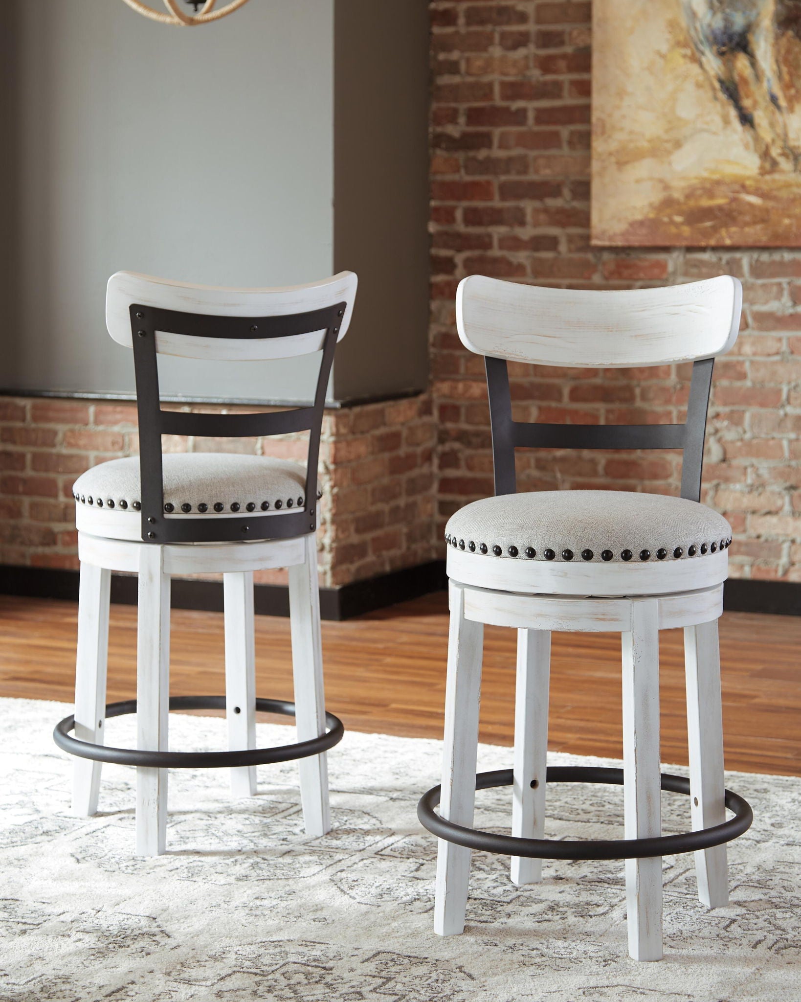 White full-back swivel bar stool with round padded seat and nailhead trim, footrest ring