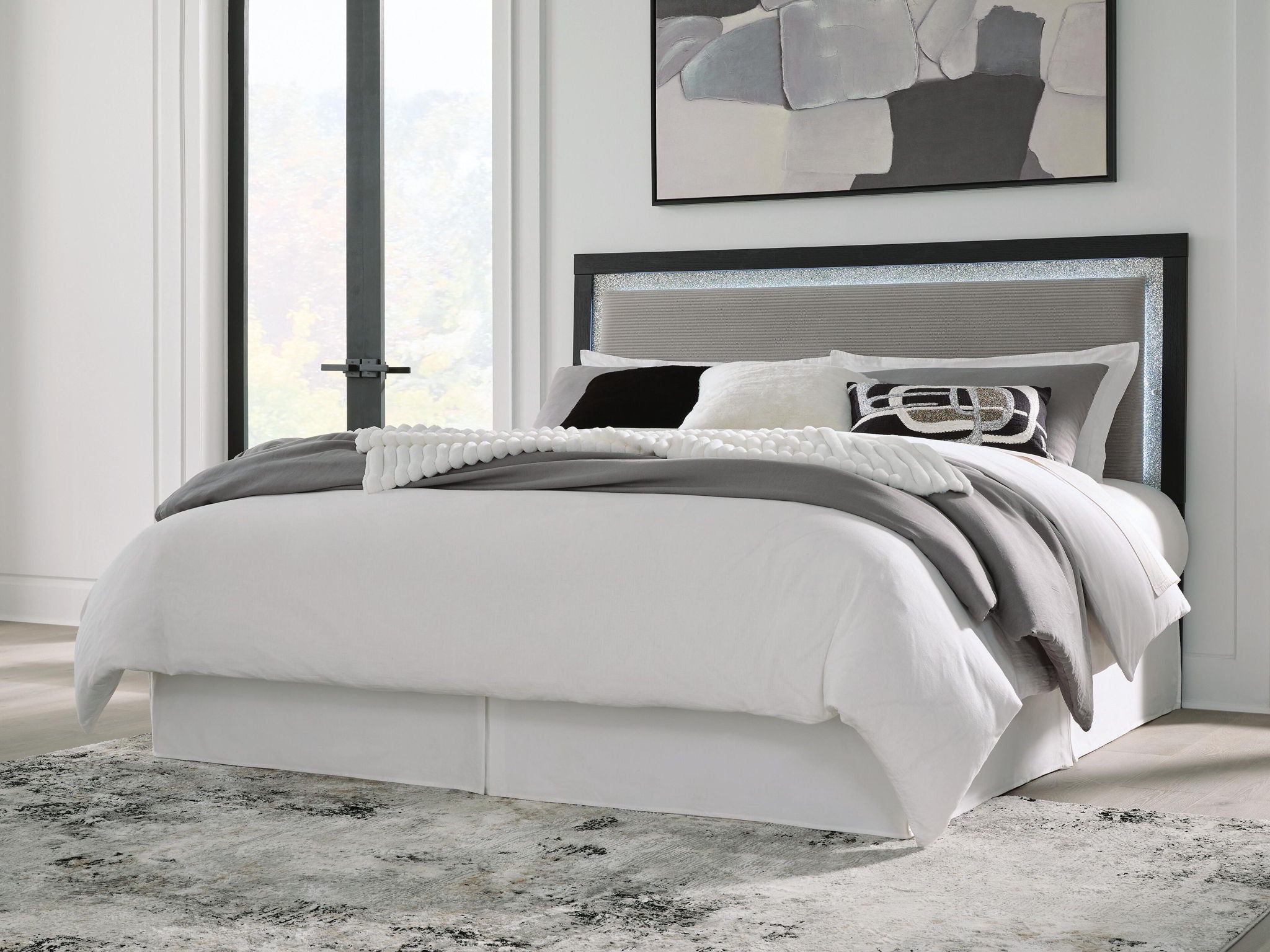 Light gray upholstered panel headboard with dark frame and textured inset backing.