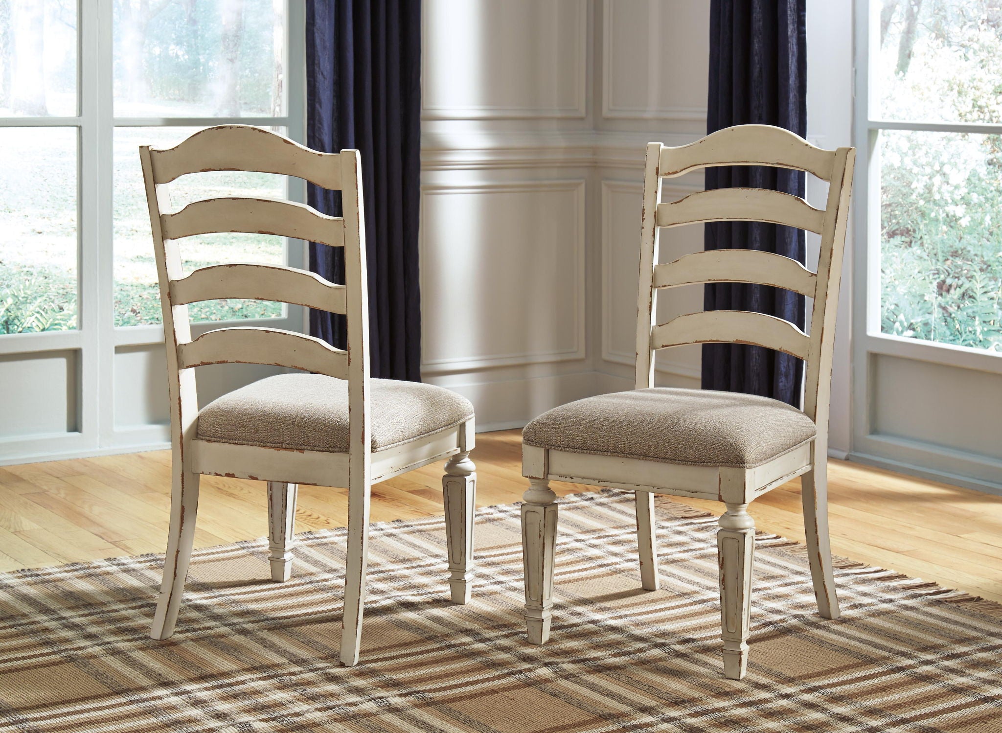 Pair of distressed white ladderback dining chairs with gray upholstered square seats
