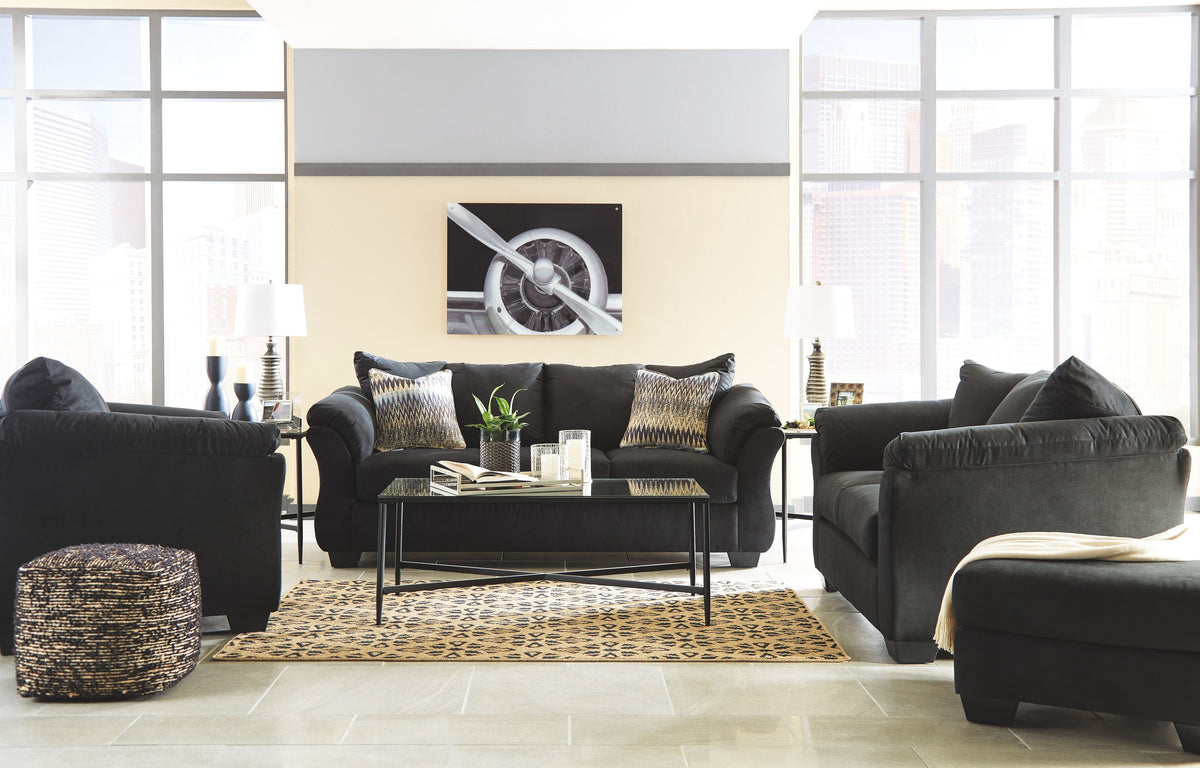 Living room set with dark sofa and loveseat, matching pillows and padded track arms