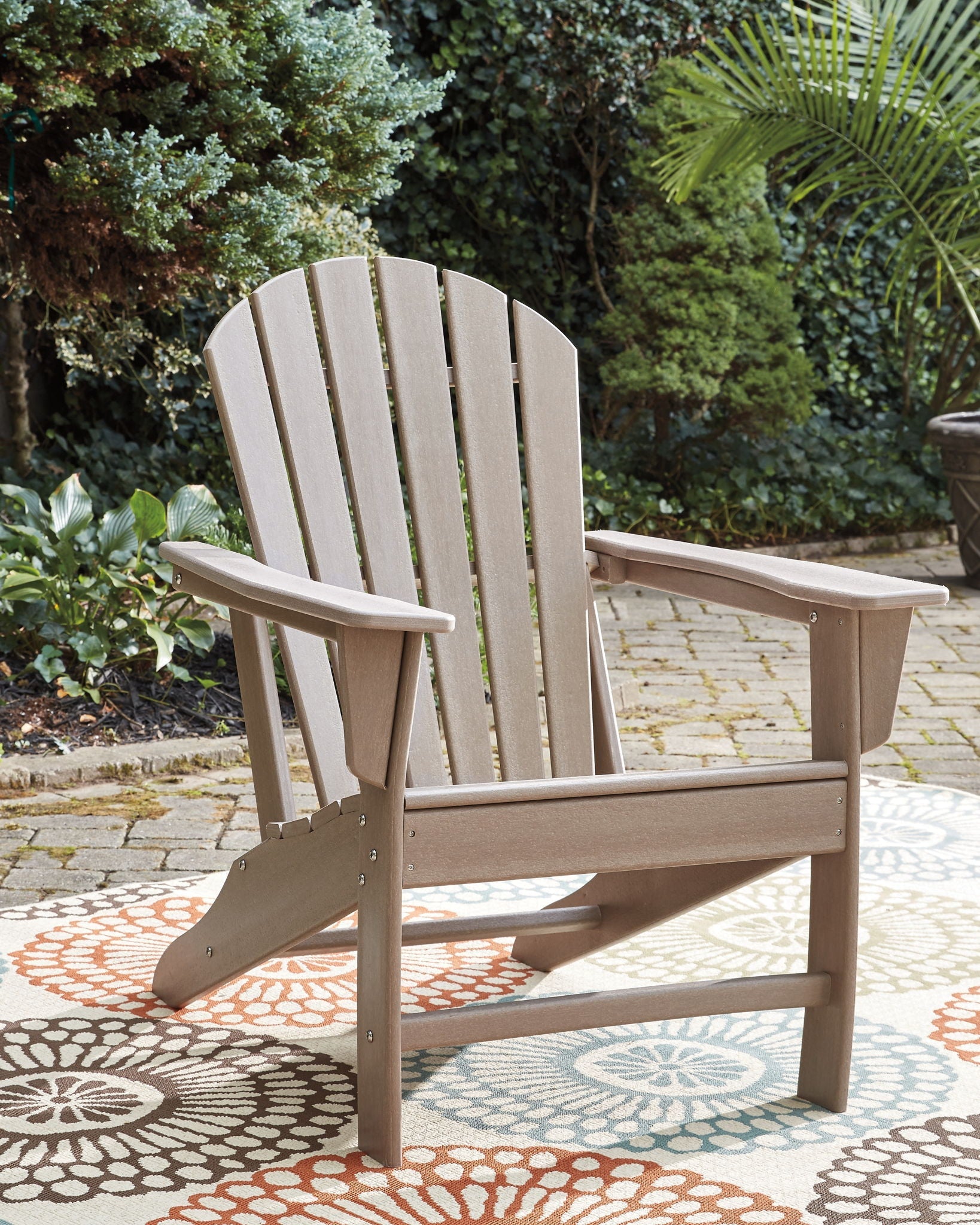 Driftwood Adirondack chair with wide slatted back and curved arms