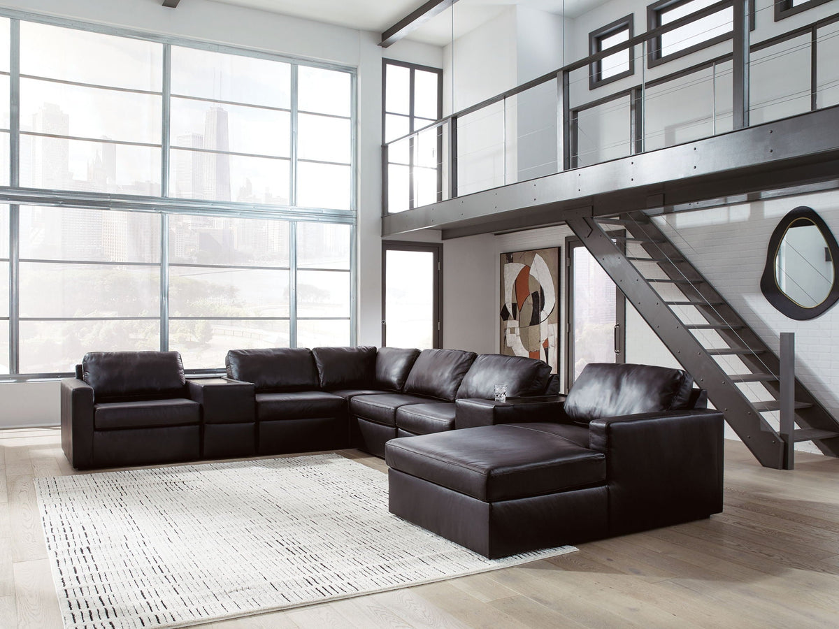 Sectional sofa with chaise and ottoman-style corner, dark leather-look upholstery