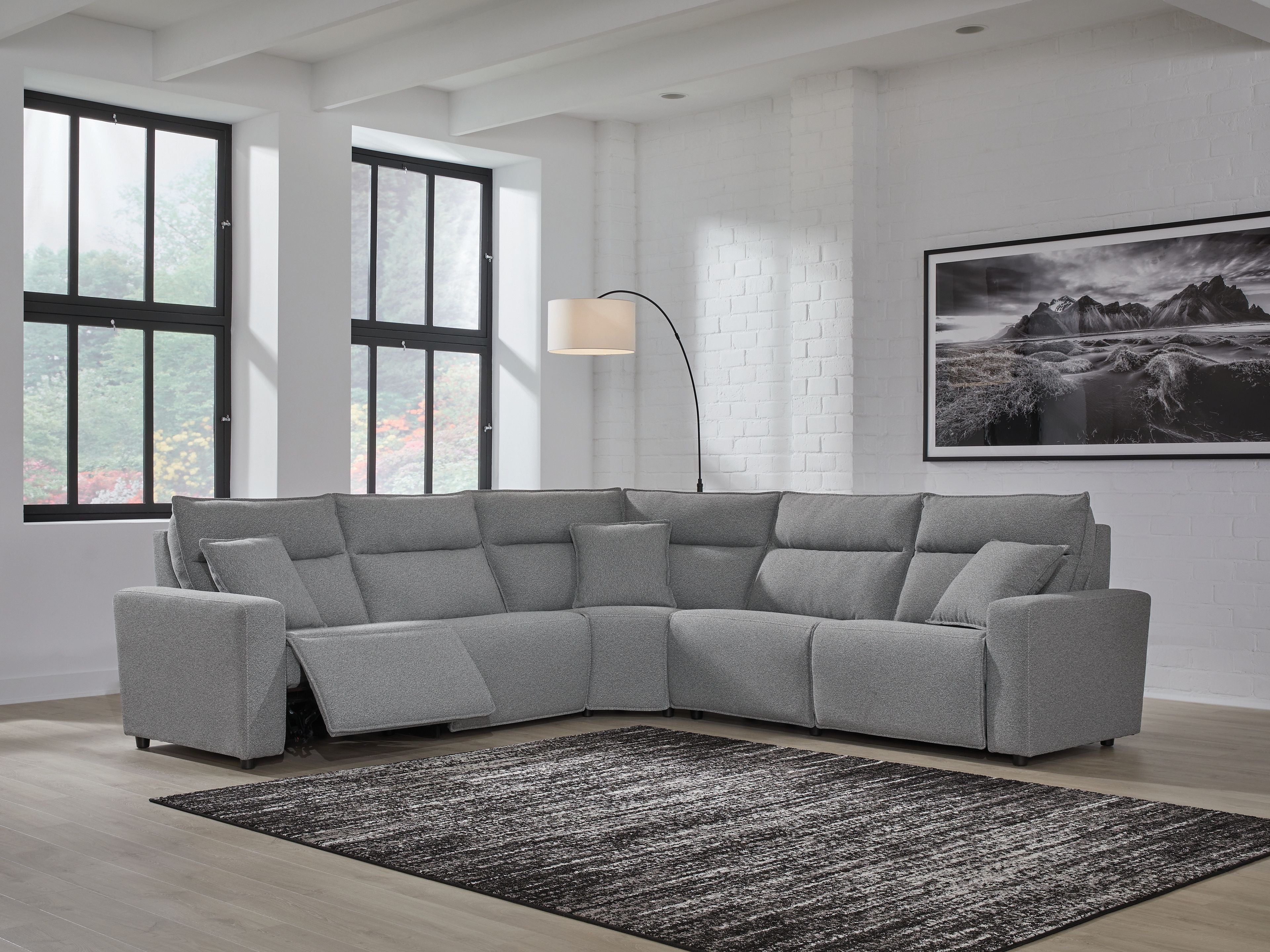 Salt-and-pepper grey sectional sofa with corner chaise, reclining seats, and clean, boxy arms