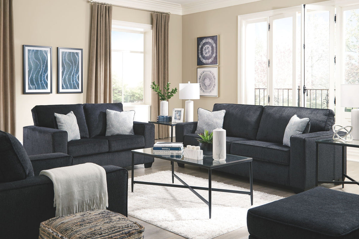 Dark gray fabric sofa and loveseat with throw pillows