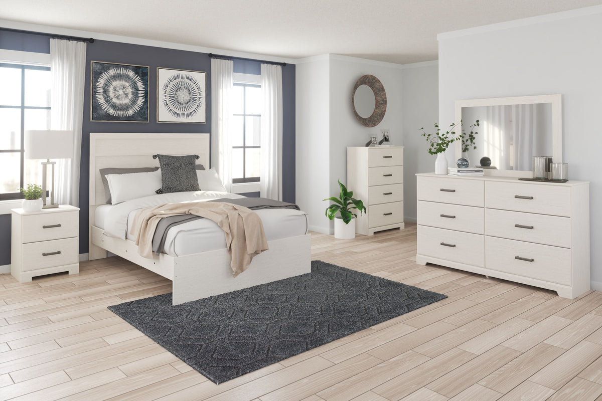 White panel bedroom set with bed, dresser, and mirror