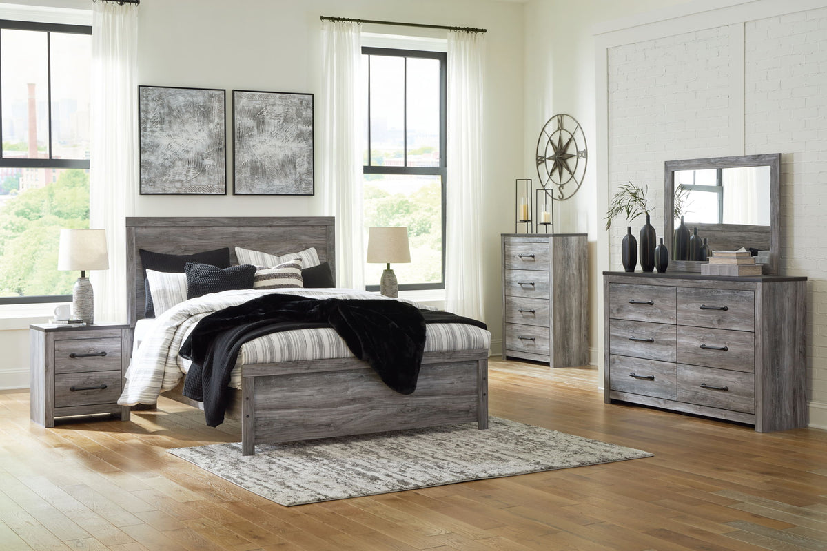 Dark gray bedroom set with bed, dresser, and wall mirror in staged room