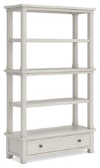 Antique white tall bookcase with open shelves and a bottom drawer.