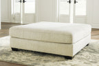 Parchment upholstered ottoman with square seat and dark base legs
