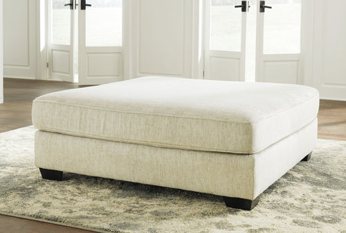 Parchment upholstered ottoman with square seat and dark base legs