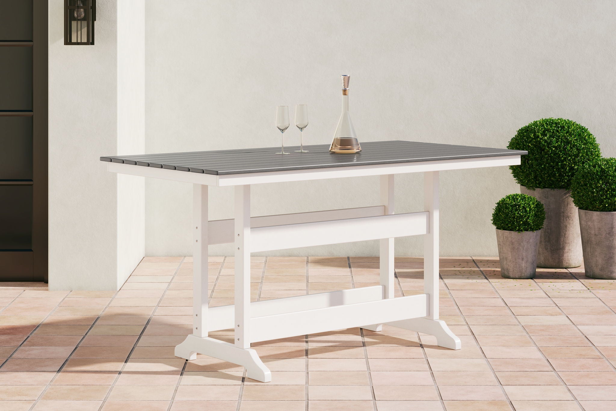 Gray slatted outdoor counter table with white crossbeam support