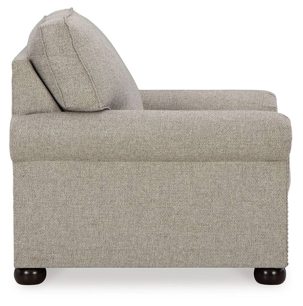 Upholstered armchair with high back, wide seat, and dark wood legs