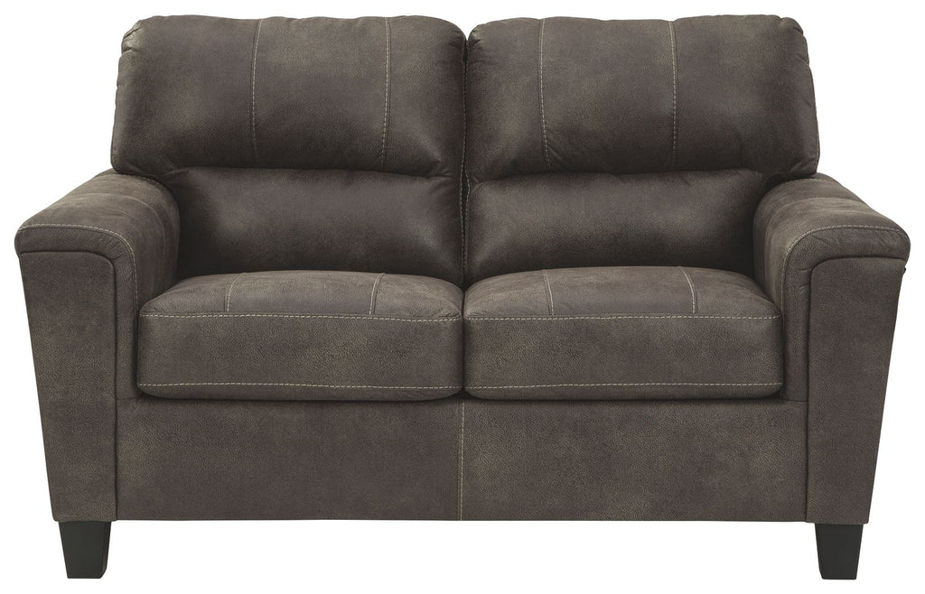 Dark gray two-seat sofa with padded arms and tufted back cushions