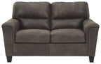 Dark gray two-seat sofa with padded arms and tufted back cushions