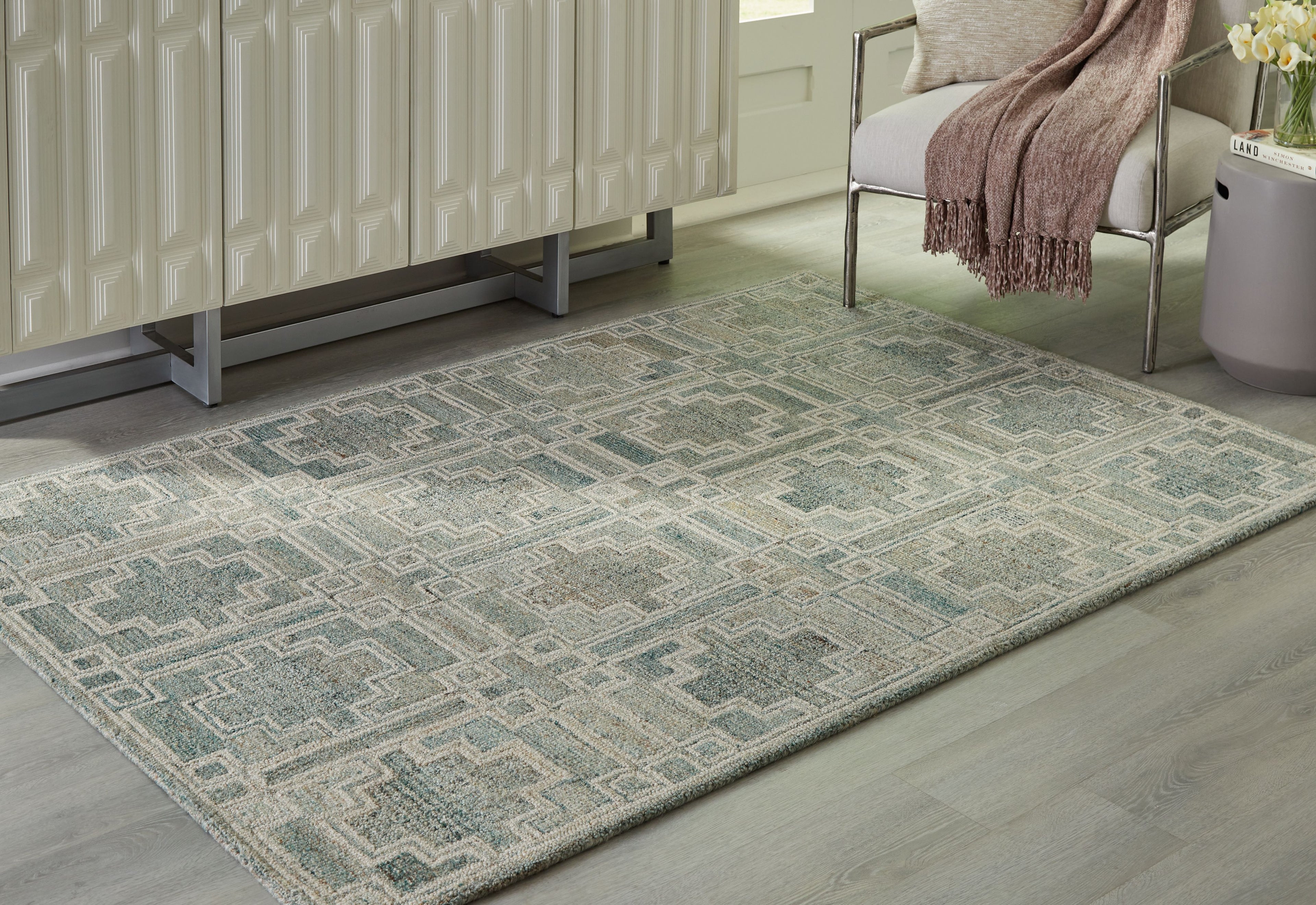 Green geometric area rug with repeating square motifs, full view