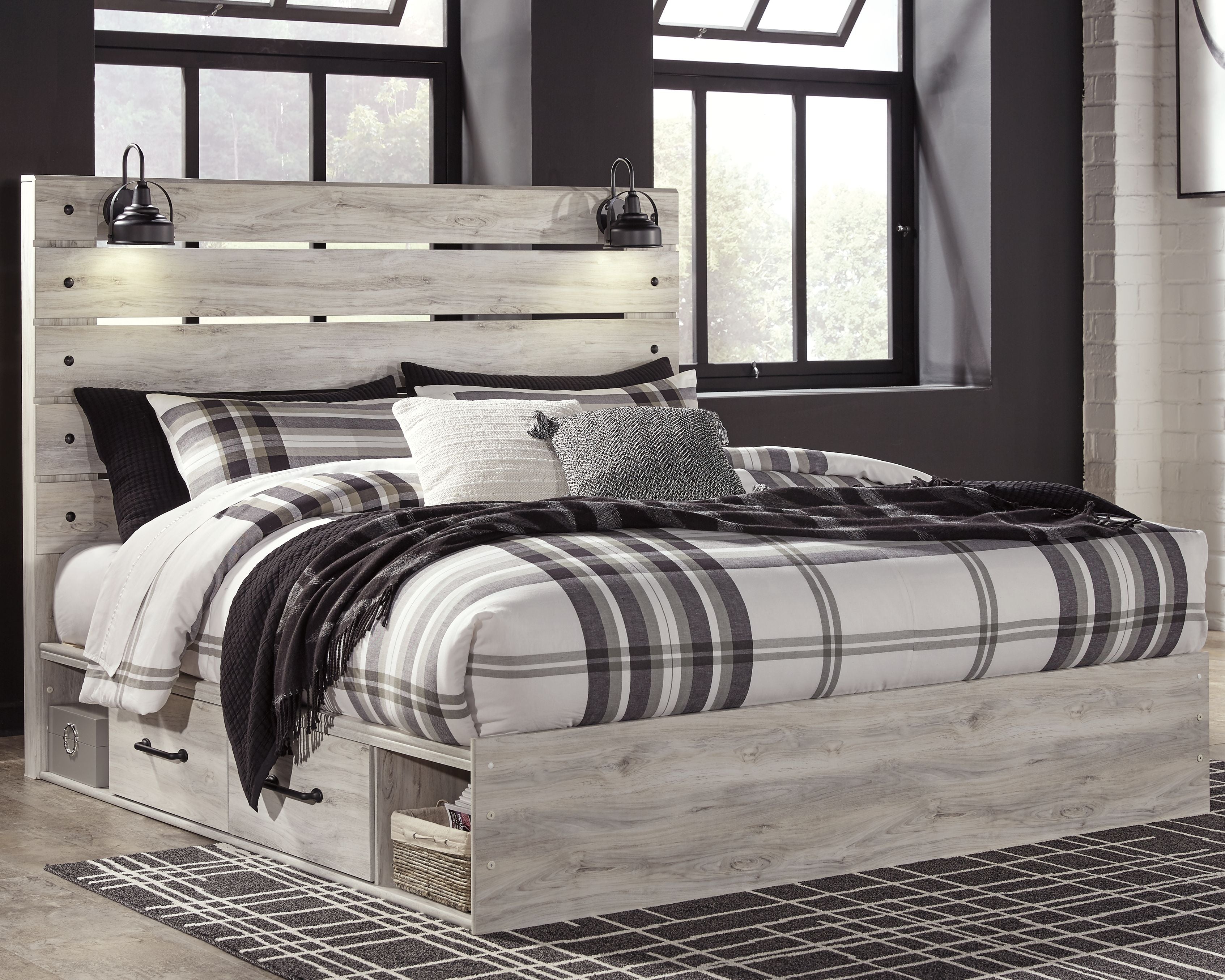 Bedroom set bed with light wood frame and plaid bedding with dark accent pillows