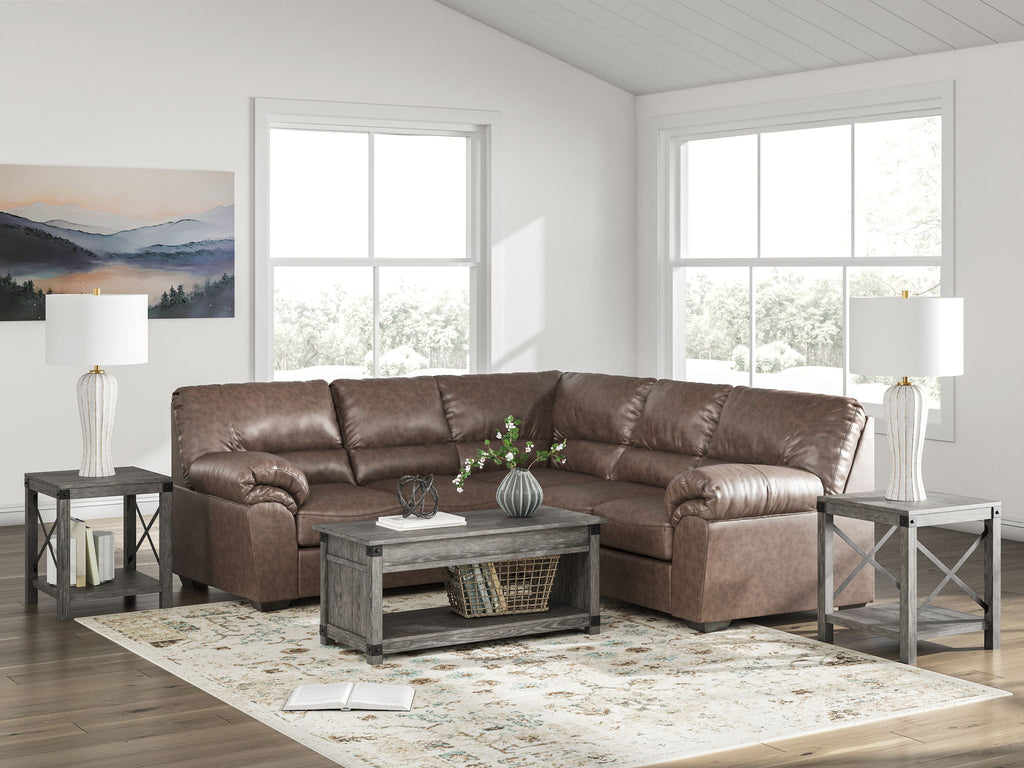 Brown sectional sofa with tufted cushions and rolled armrests