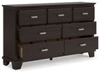 Dark brown dresser with open-front view of six drawers and silver bar handles