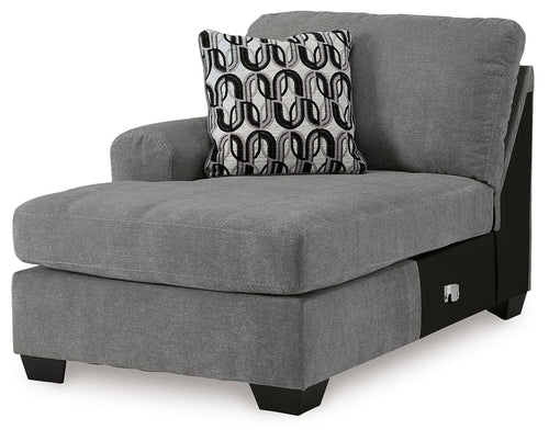 Gray corner chaise lounge with upholstered back, patterned throw pillow, black legs