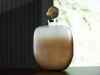 Decorative jar with frosted rounded body and gold-tone ornate hinged lid