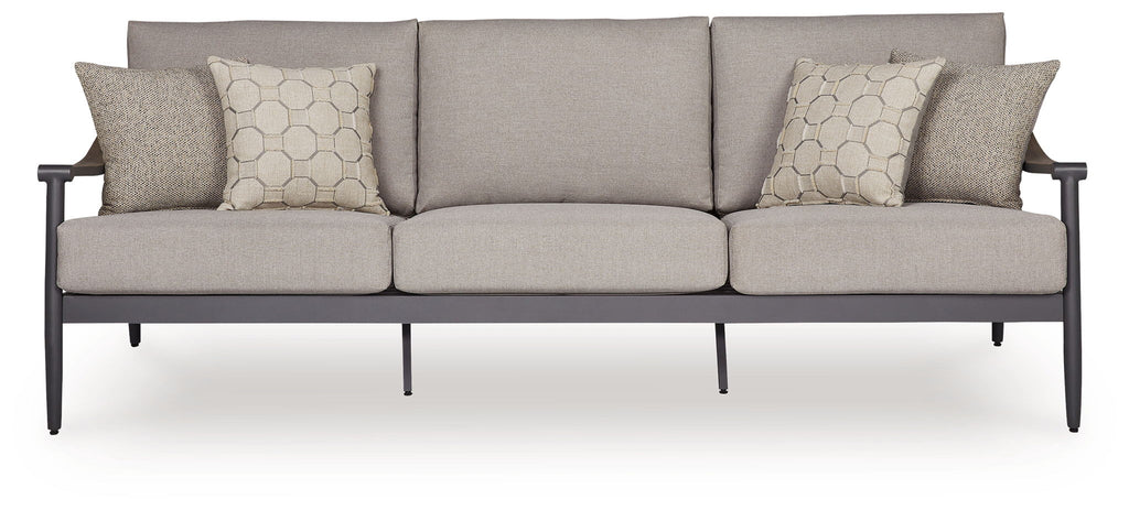 Gray outdoor sofa with three seat cushions and two geometric throw pillows, dark arms
