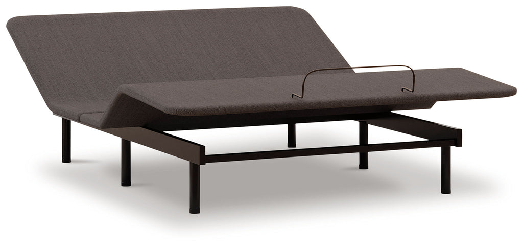Adjustable bed base with dark fabric cover and black legs, side view