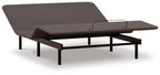 Adjustable bed base with dark fabric cover and black legs, side view
