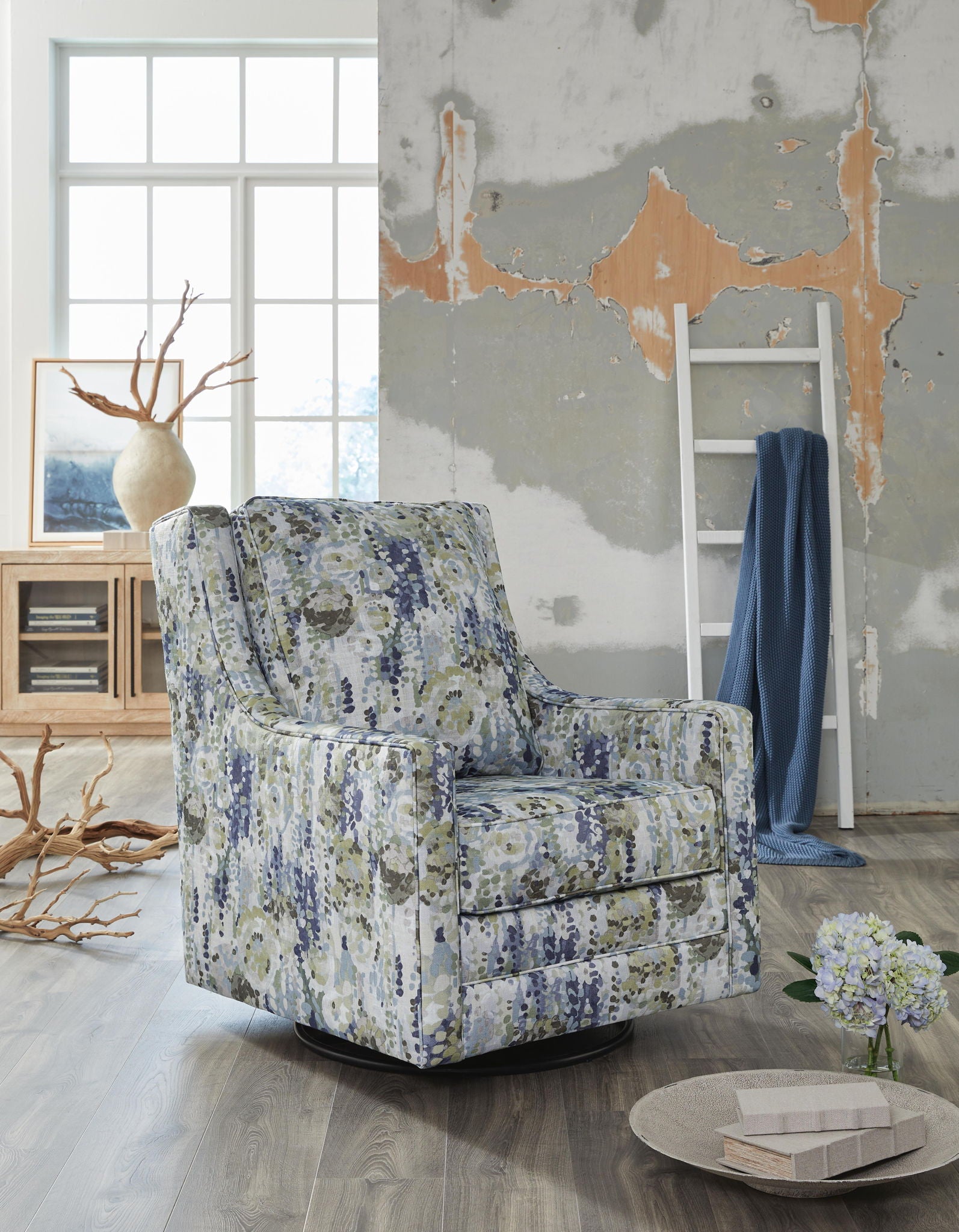 Upholstered swivel glider accent chair with speckled blue, green, and beige fabric