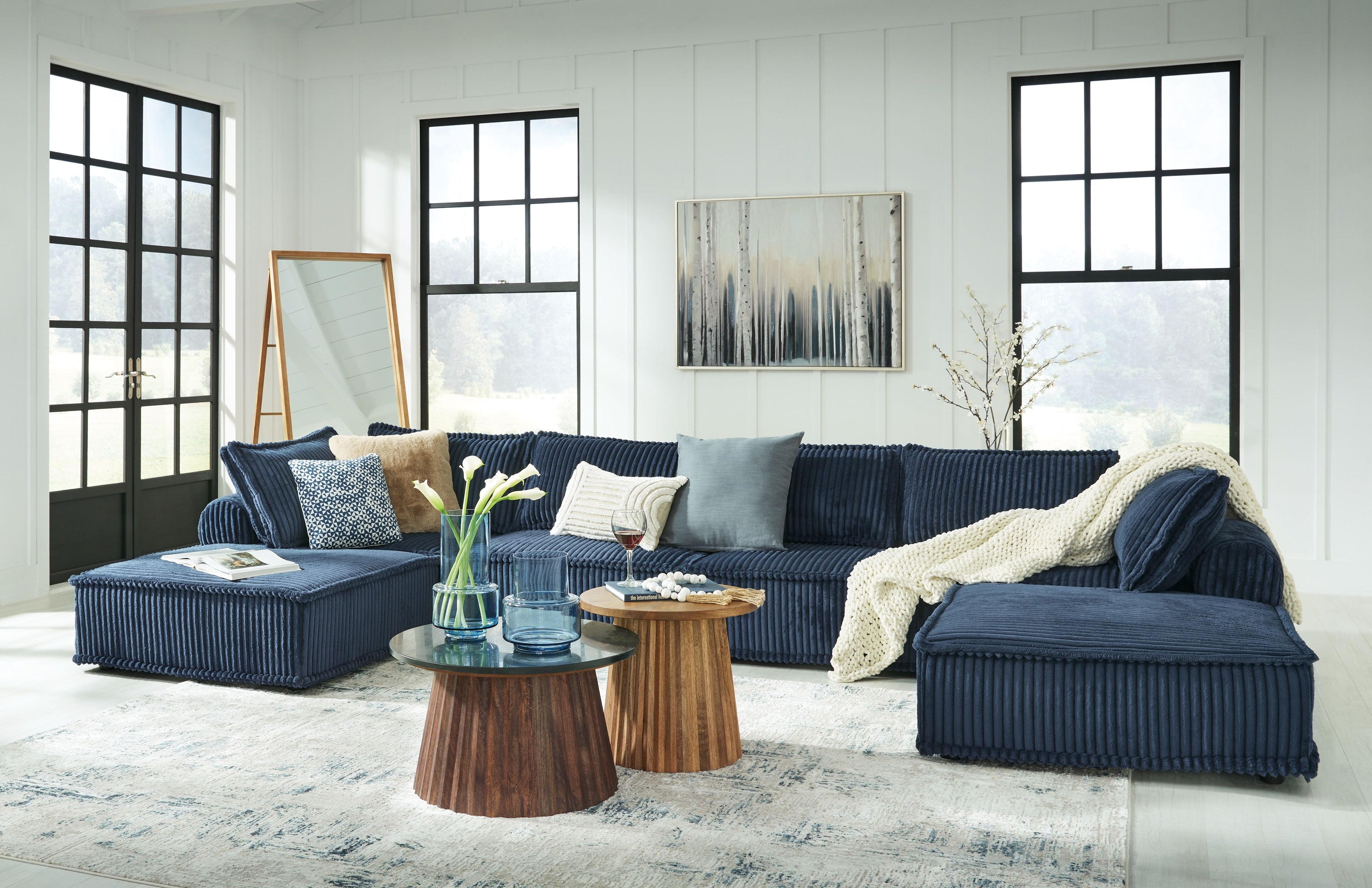 Navy modular sectional sofa with accent pillows and open chaise seating