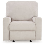 Rocker recliner chair in light beige upholstered fabric with front armrests and seat pad.