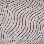Table lamp base close-up with distressed white texture and terracotta wavy lines