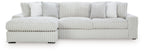Sectional sofa with chaise, light-colored striped upholstery and padded arm cushions