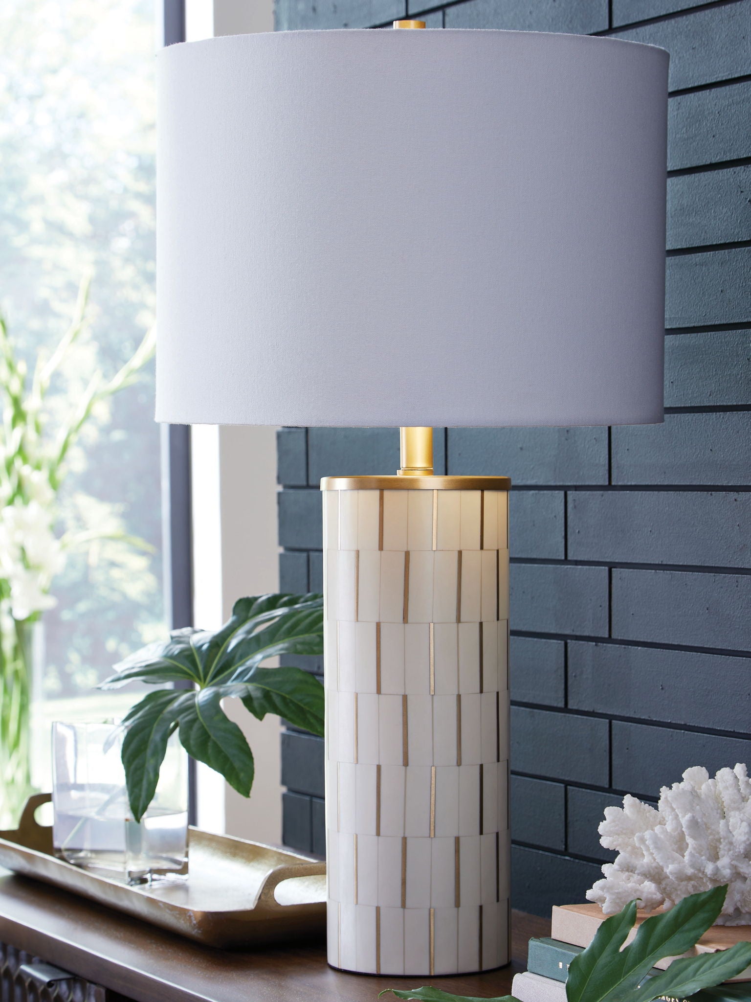 White poly table lamp with fabric shade and gold stem, ribbed cylinder body