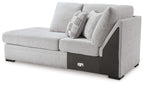 Corner chaise in light gray upholstery with two pillows and dark side arm panel