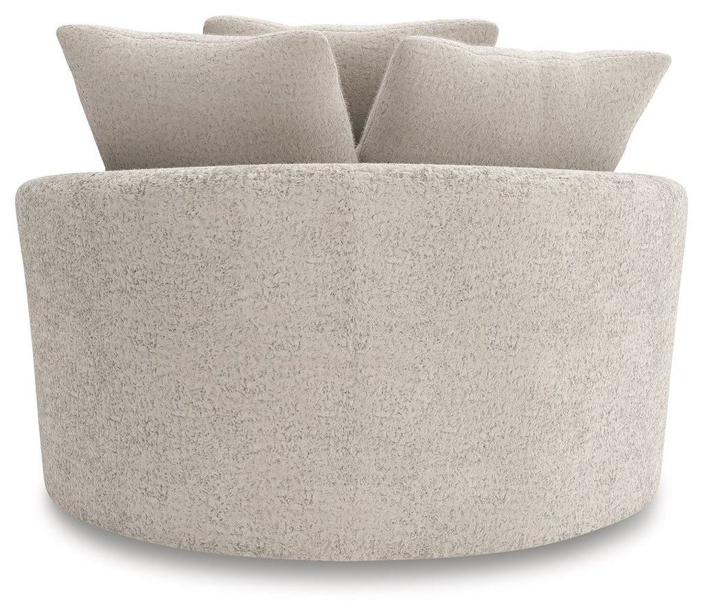 Swivel accent chair with thick curved seat and textured light beige fabric.