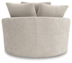 Swivel accent chair with thick curved seat and textured light beige fabric.