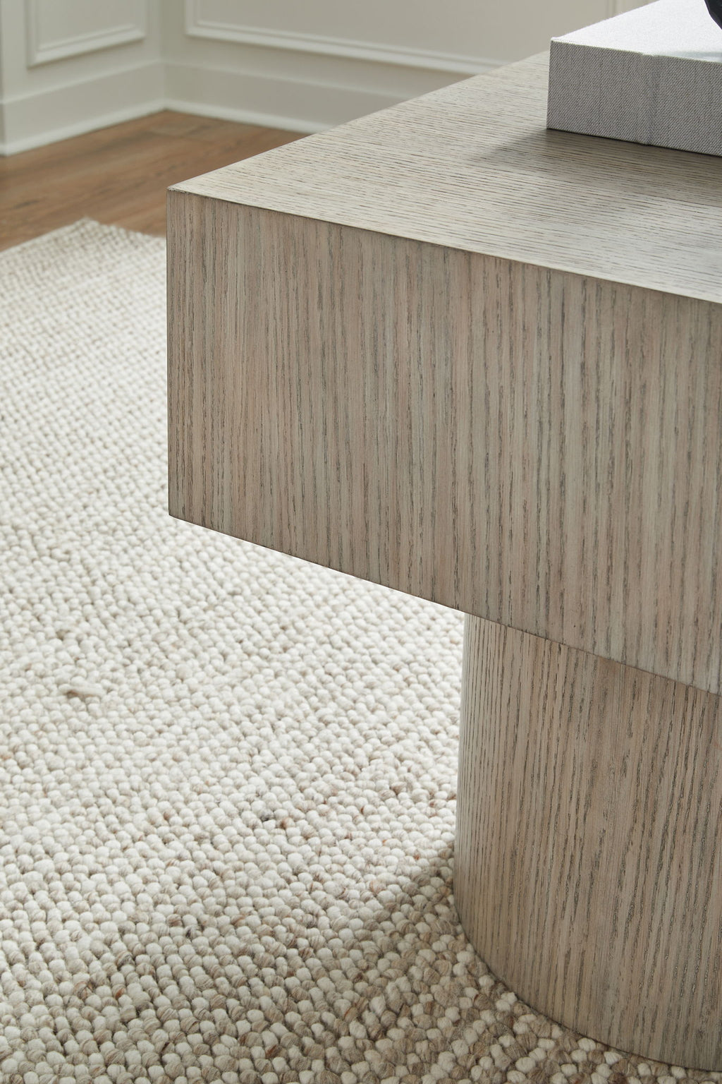 Light brown square table with visible wood grain and straight side