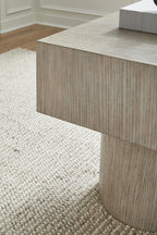 Light brown square table with visible wood grain and straight side