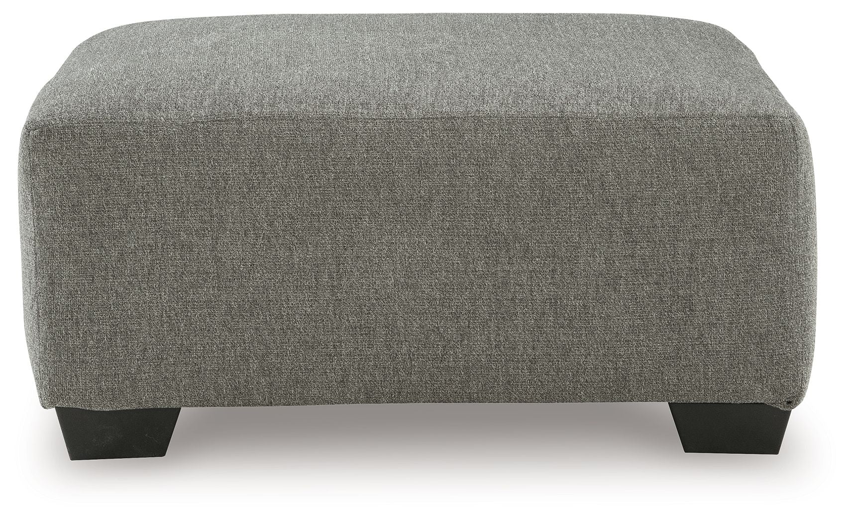 Boxy gray upholstered ottoman with dark legs and rounded top edge