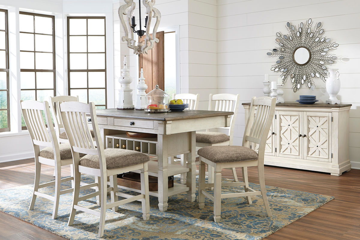 Beige dining table set with rectangular table, cushioned chairs, and buffet server
