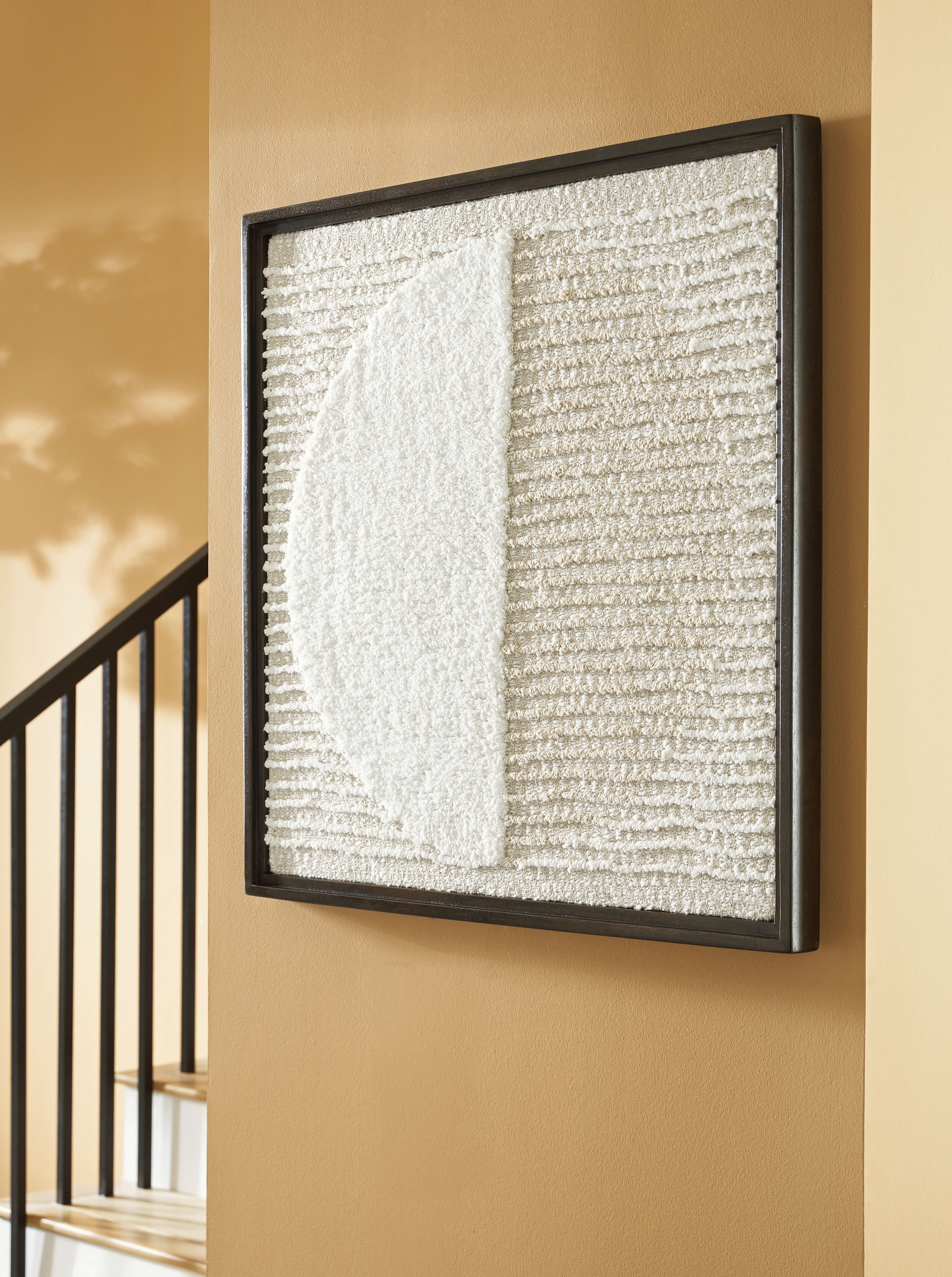 Framed wall decor with tan-and-white textured fabric and a large vertical white panel