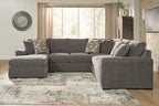 Gray sectional sofa with chaise, decorative patterned pillows, and wide chaise cushion