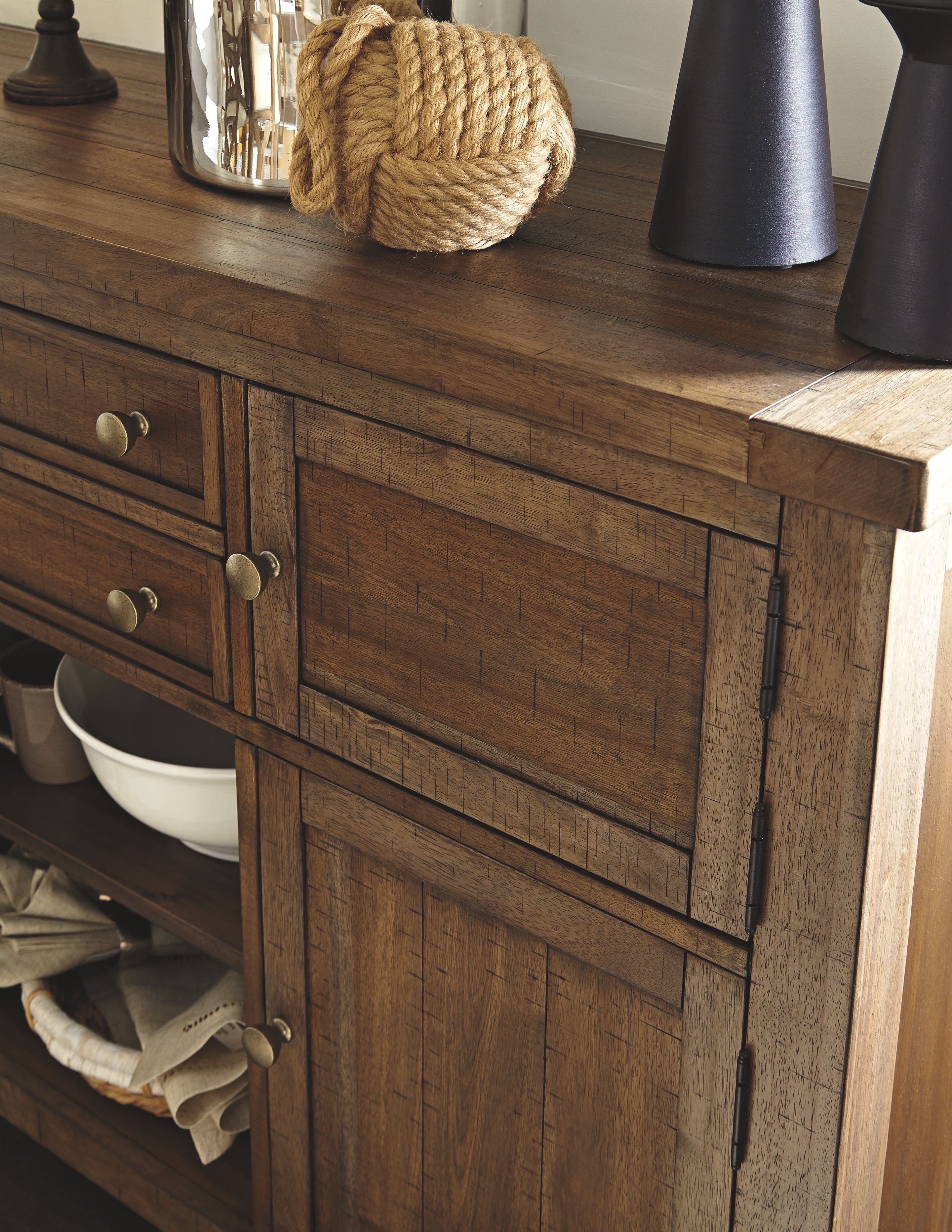 Wood server cabinet with drawers and doors, showing dark finish and metal knobs