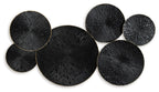 Black and gold circular wall decor with seven fan-textured discs, overlapping