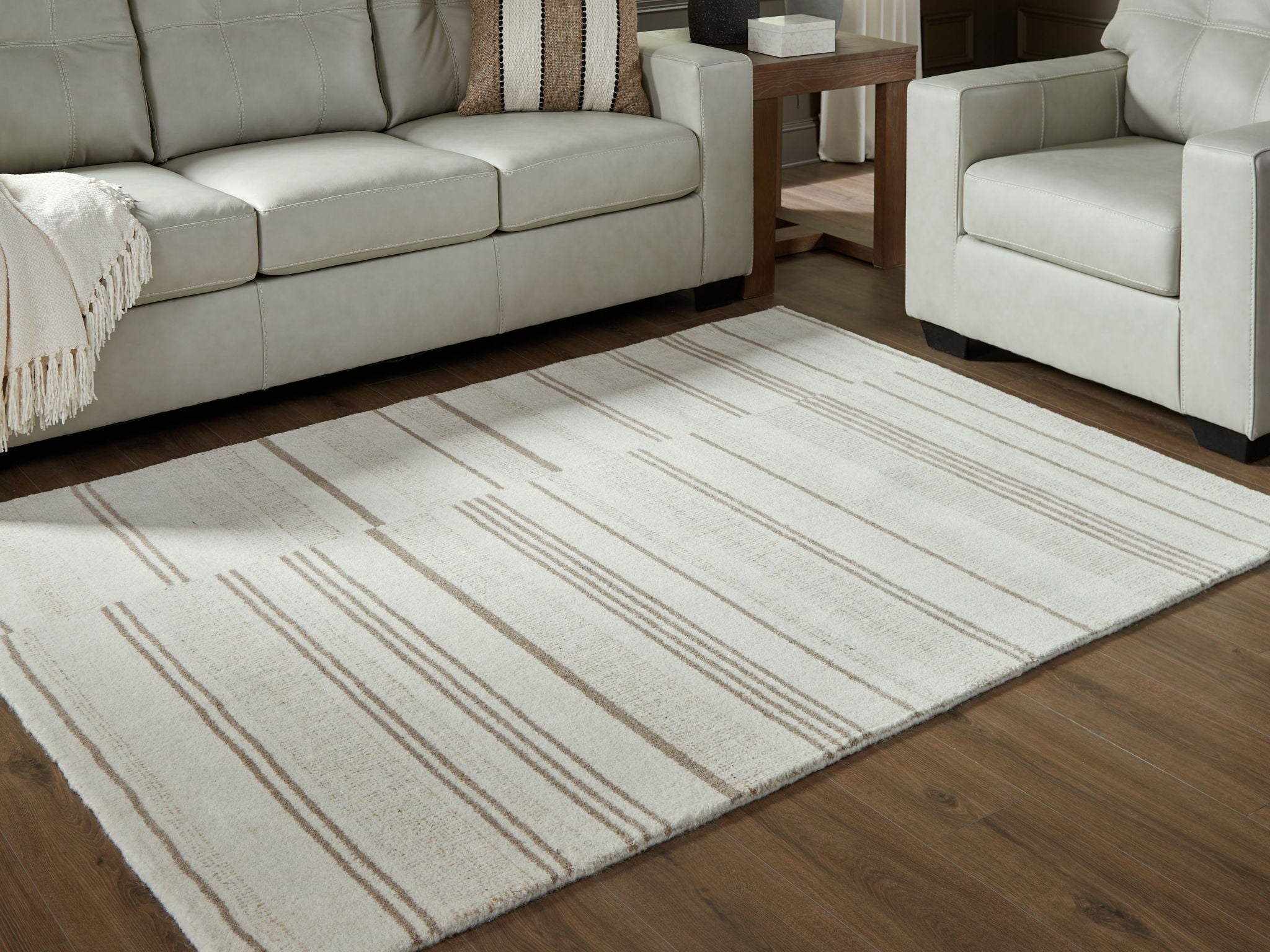 Rectangular off-white area rug with beige horizontal stripe pattern